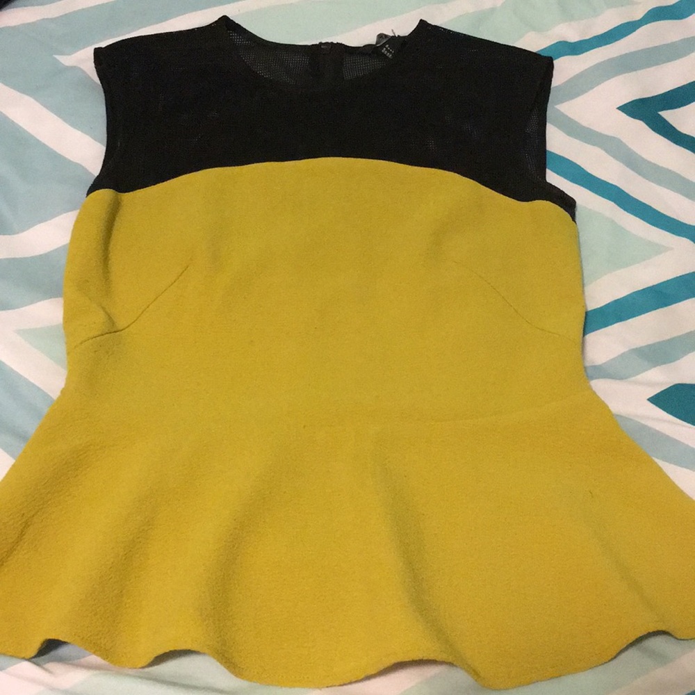 Green sleeveless top with black mesh at shoulders